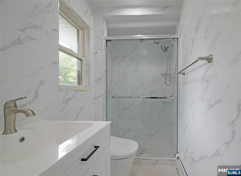 819 Ridgewood Road Millburn, NJ 07041 - Photo 20 of 39 a bathroom with a sink a toilet and shower