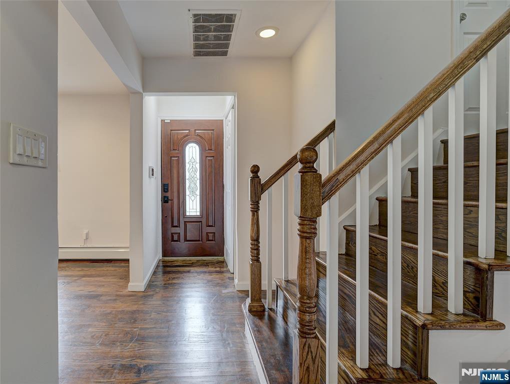 819 Ridgewood Road Millburn, NJ 07041 - Photo 2 of 39 a view of a hallway with wooden floor and stairs