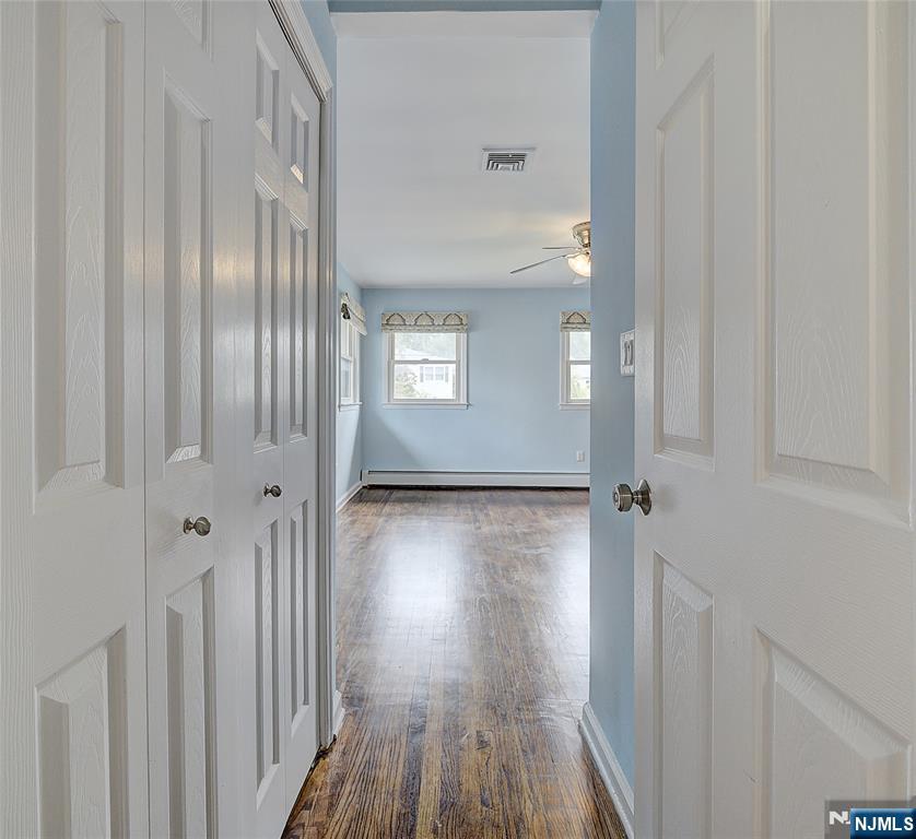819 Ridgewood Road Millburn, NJ 07041 - Photo 21 of 39 a view of a hallway with wooden floor and staircase
