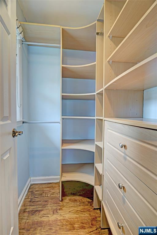 819 Ridgewood Road Millburn, NJ 07041 - Photo 22 of 39 a view of walk in closet with empty racks