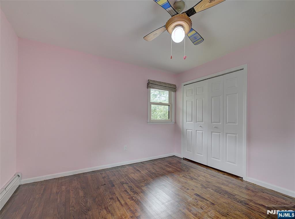 819 Ridgewood Road Millburn, NJ 07041 - Photo 24 of 39 wooden floor in an empty room with a window