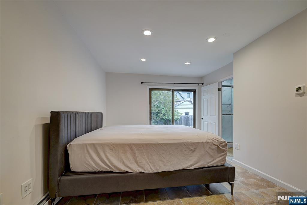 819 Ridgewood Road Millburn, NJ 07041 - Photo 28 of 39 a bedroom with a bed and a window