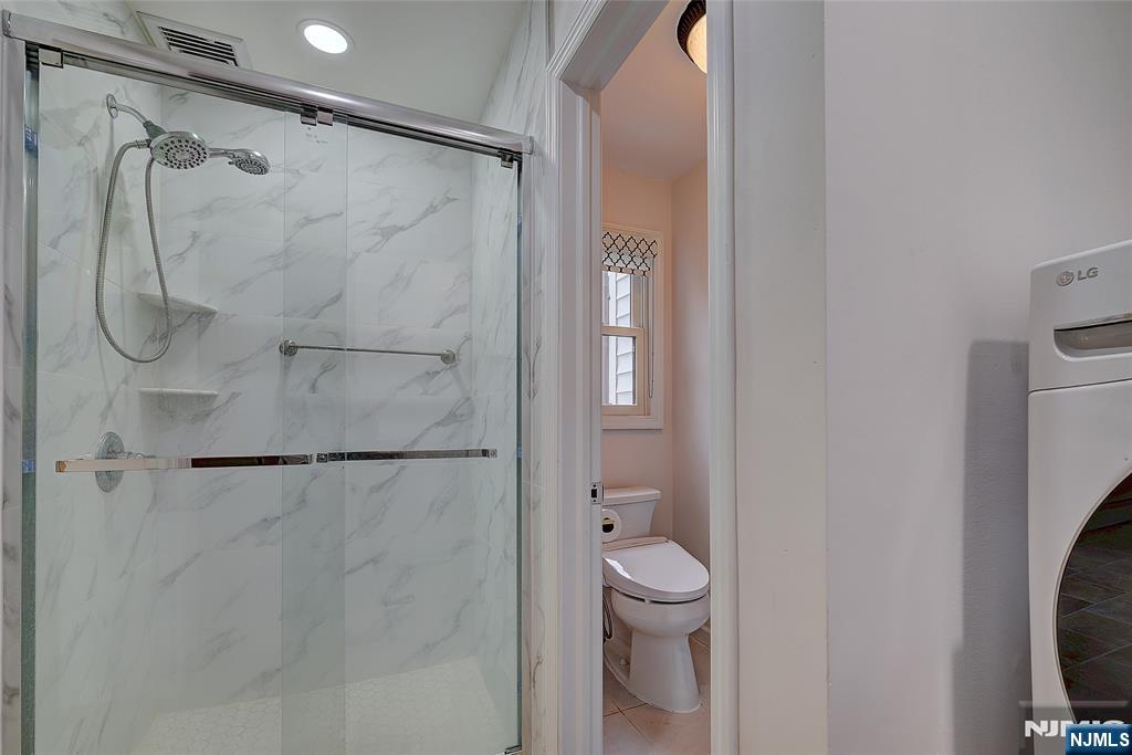 819 Ridgewood Road Millburn, NJ 07041 - Photo 30 of 39 a bathroom with a shower a toilet and a shower