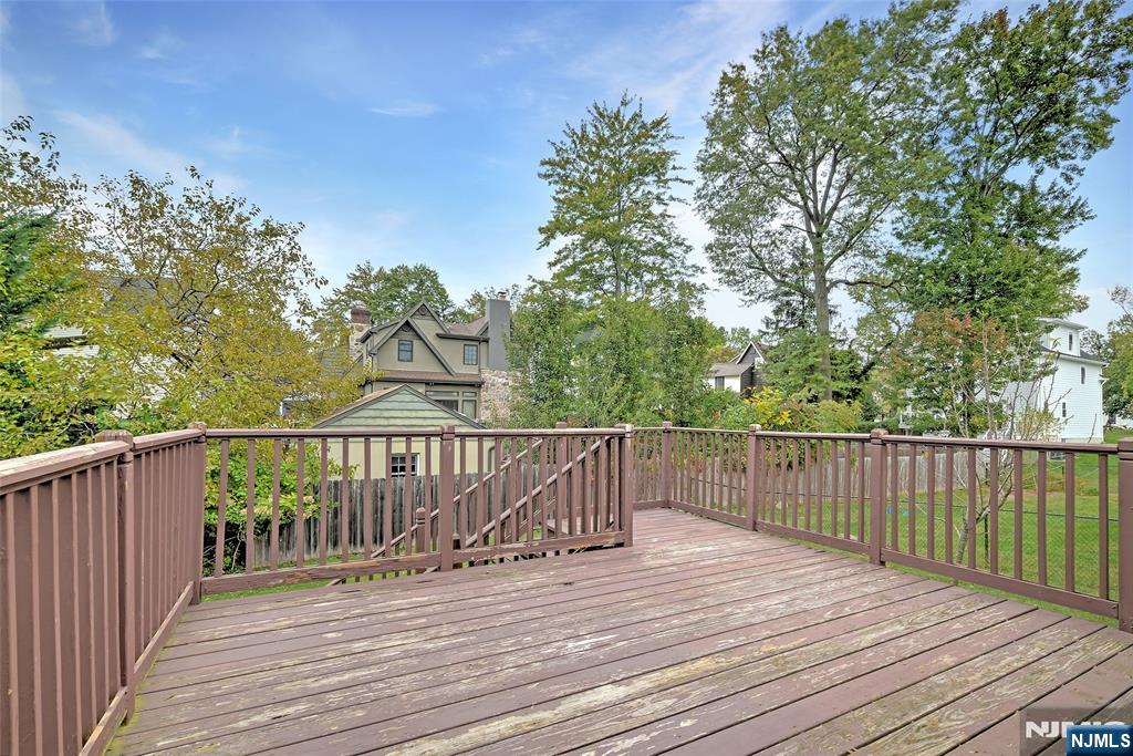 819 Ridgewood Road Millburn, NJ 07041 - Photo 36 of 39 a view of deck with wooden floor and fence and trees