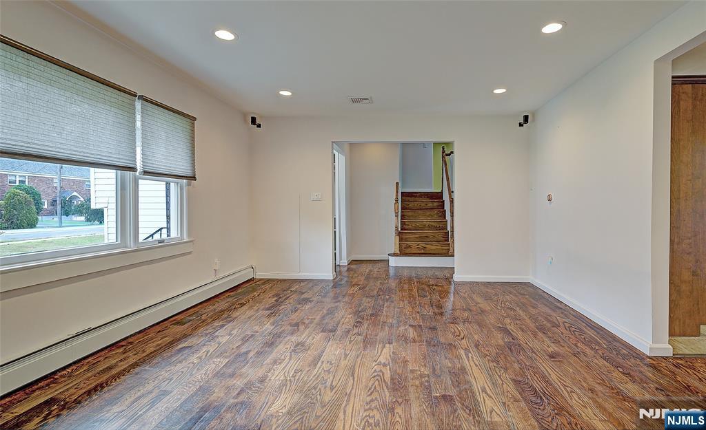 819 Ridgewood Road Millburn, NJ 07041 - Photo 6 of 39 a view of an empty room with wooden floor and a window