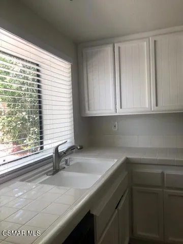 a kitchen with a sink and cabinets