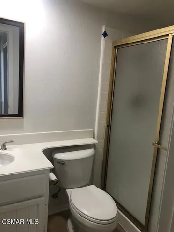 a white toilet sitting next to a bathroom sink