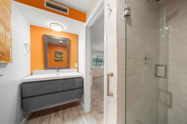a view of a hallway with wooden floor and entryway