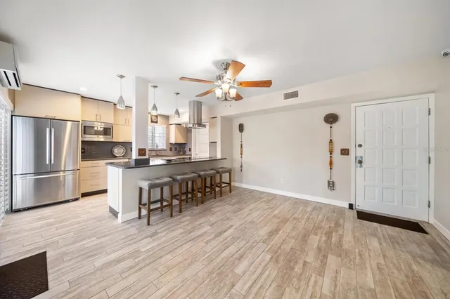 a kitchen with stainless steel appliances granite countertop a sink and a stove