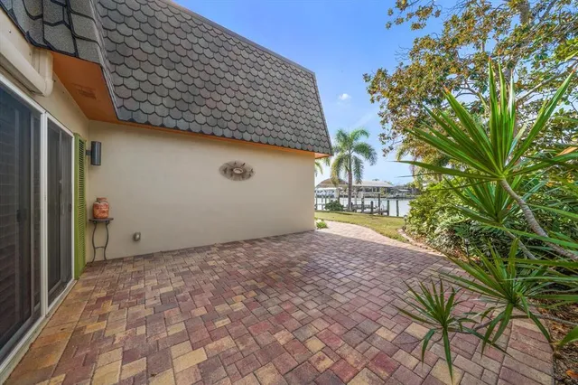 an aerial view of a house with swimming pool and outdoor seating