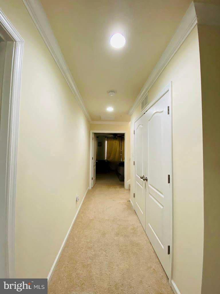 7014 Foxton Way Hanover, MD 21076 - Photo 15 of 29 Inviting hallway with soft lighting.