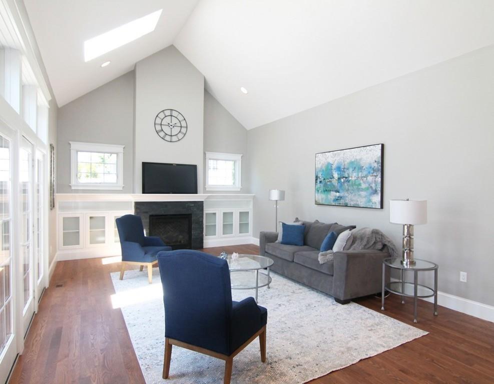 18 Hathaway Road Lexington, MA 02420 - Photo 11 of 39 a living room with furniture a fireplace and a flat screen tv