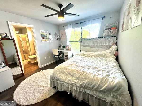 a bed sitting in a bedroom next to a window