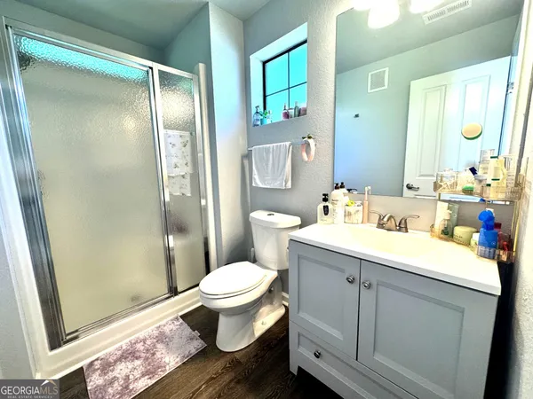 a bathroom with a sink toilet and shower