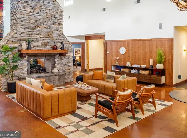 a living room with patio furniture and a fireplace