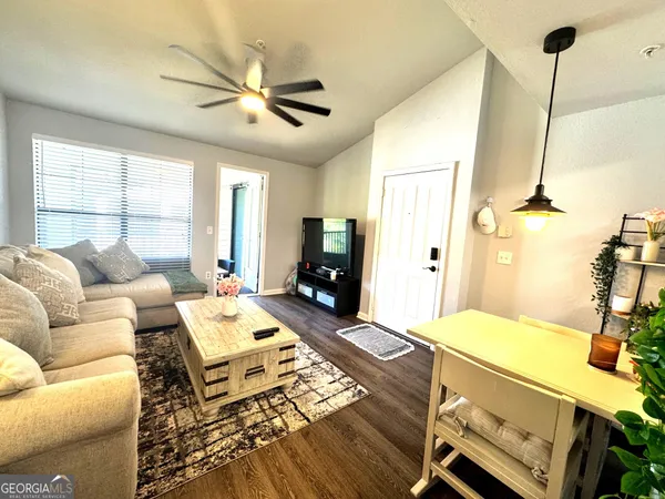 a living room with furniture and a flat screen tv