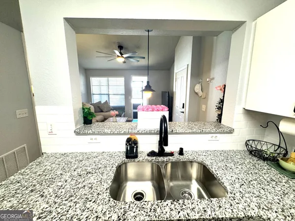 a kitchen with a sink a counter top space and cabinets