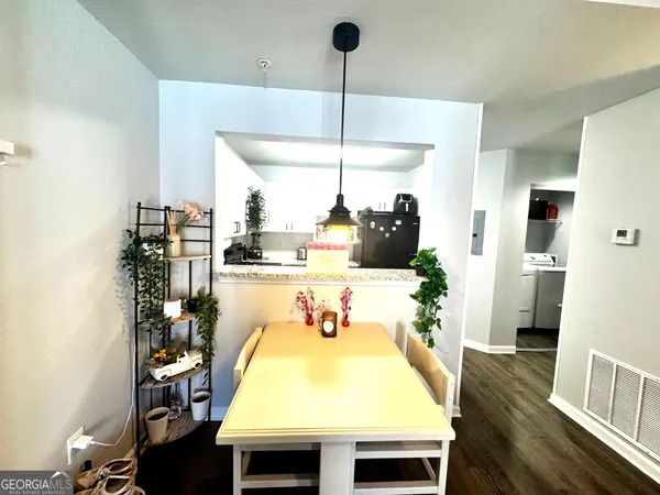 a living room with a table and chairs