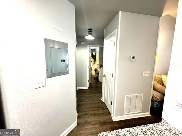 a view of a hallway with wooden floor and staircase