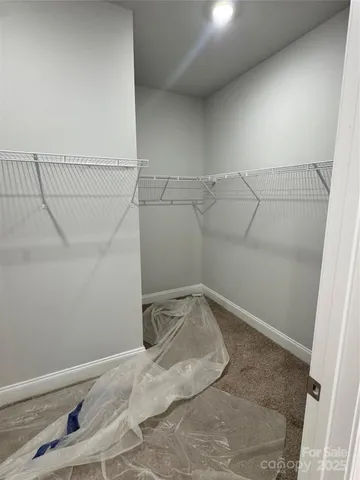 a large kitchen with kitchen island a large counter space a sink appliances and a window