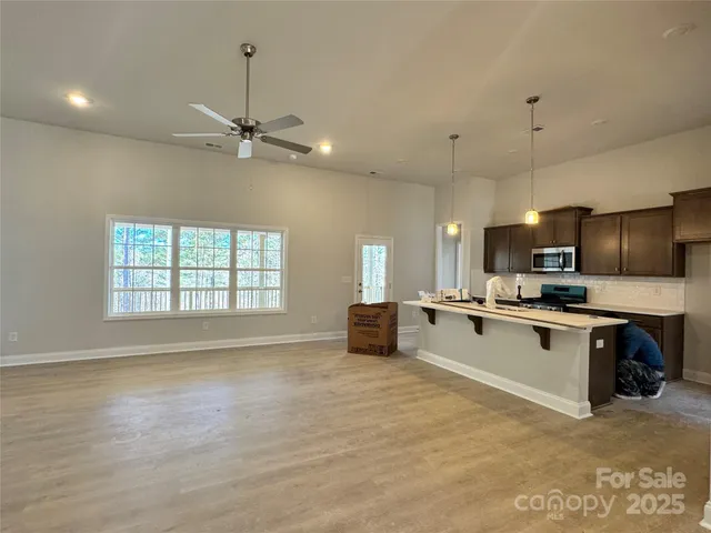 a kitchen with a stove a sink and a microwave