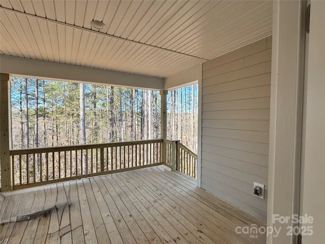 a wooden fence with trees in the background
