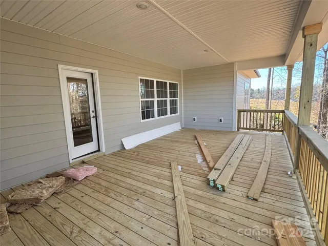 a wooden fence with trees in the background