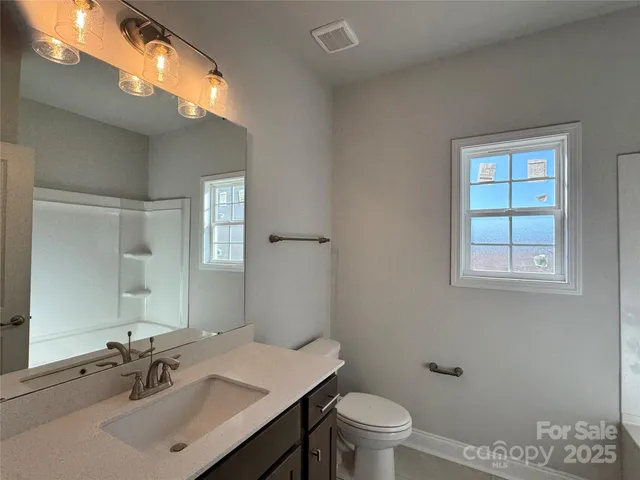 a bathroom with a sink toilet and a mirror