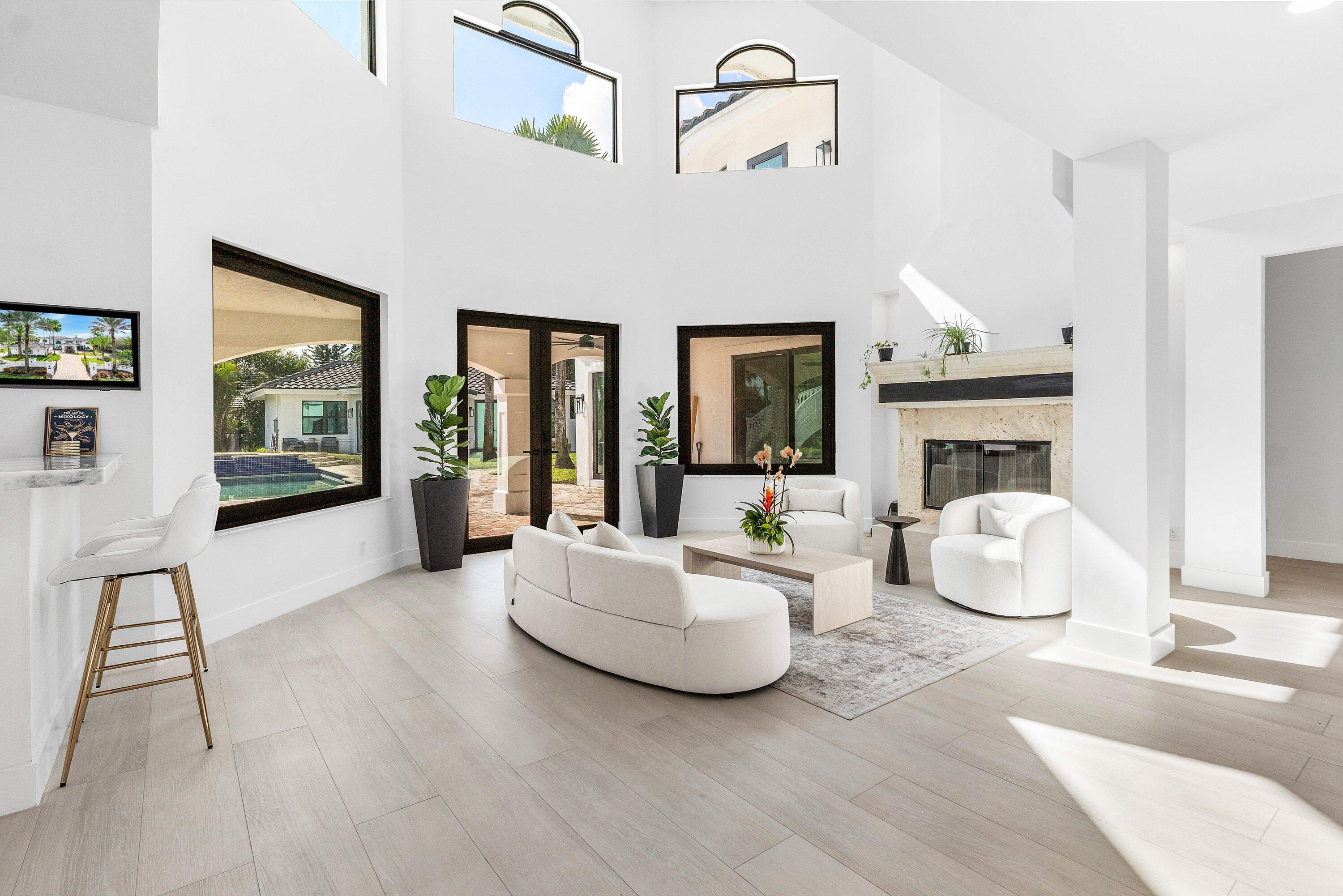 17600 Fieldbrook Circle East Boca Raton, FL 33496 - Photo 11 of 91 a living room with furniture a fireplace and a chandelier