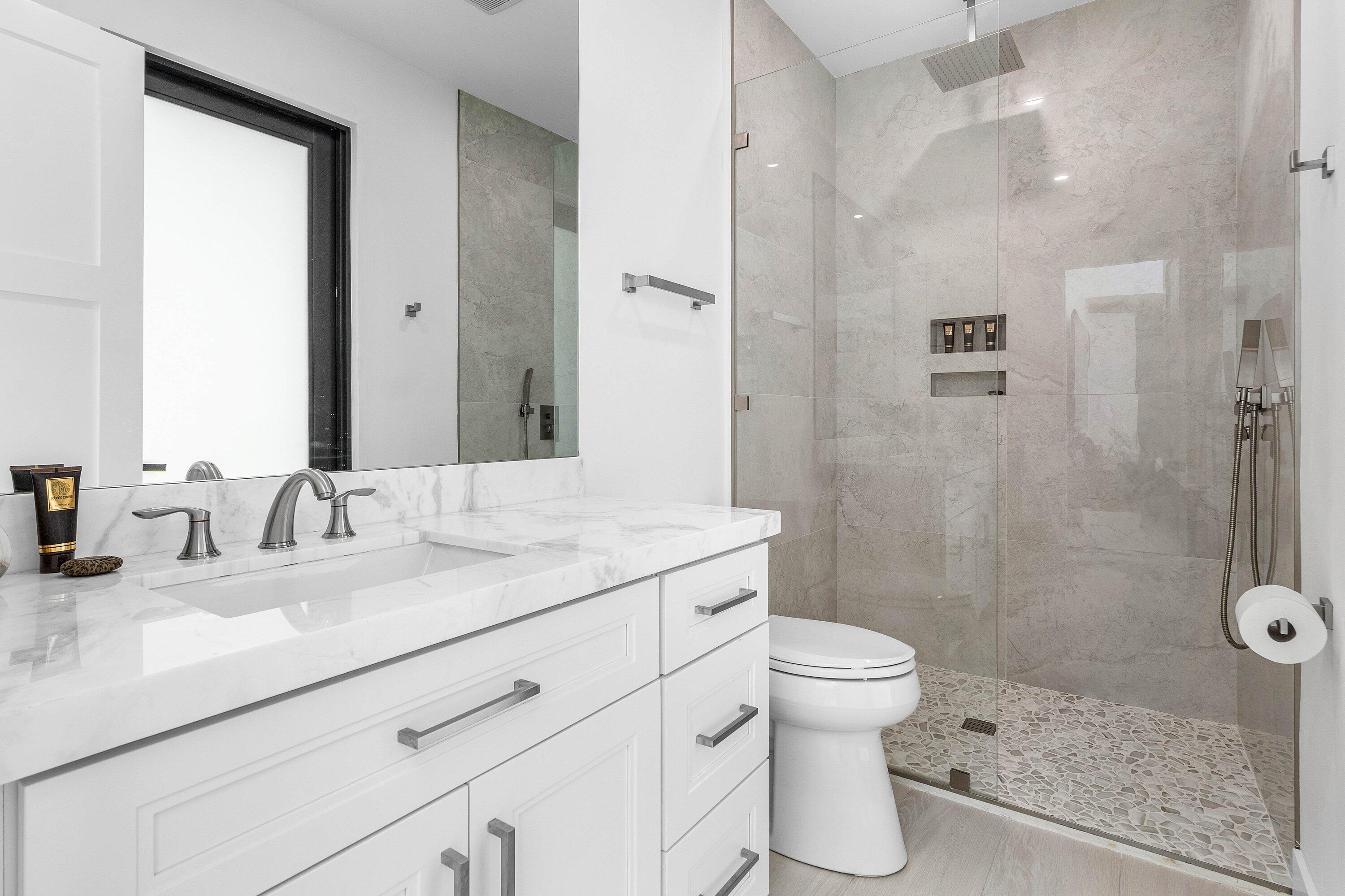 17600 Fieldbrook Circle East Boca Raton, FL 33496 - Photo 19 of 91 a bathroom with a sink toilet and shower