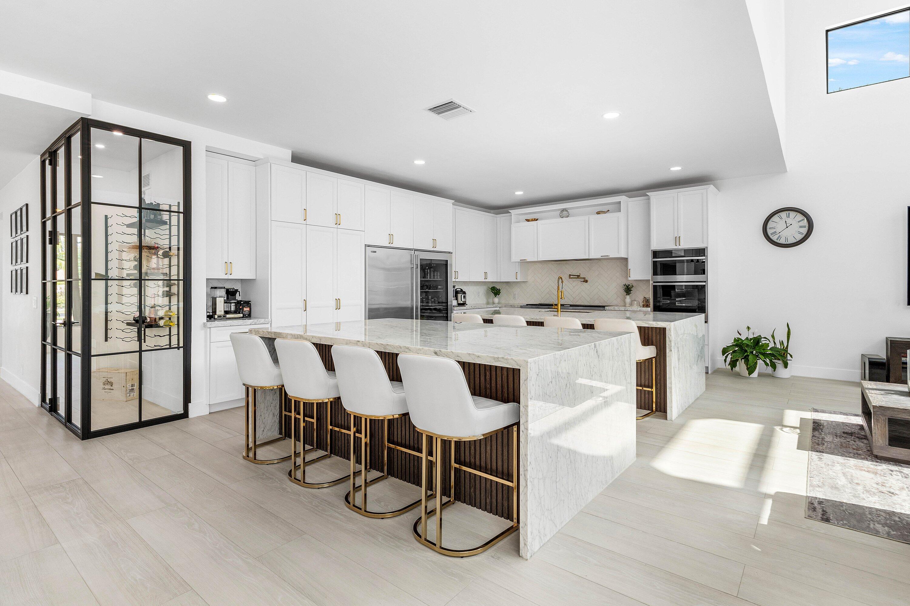 17600 Fieldbrook Circle East Boca Raton, FL 33496 - Photo 22 of 91 a large white kitchen with white cabinets and stainless steel appliances