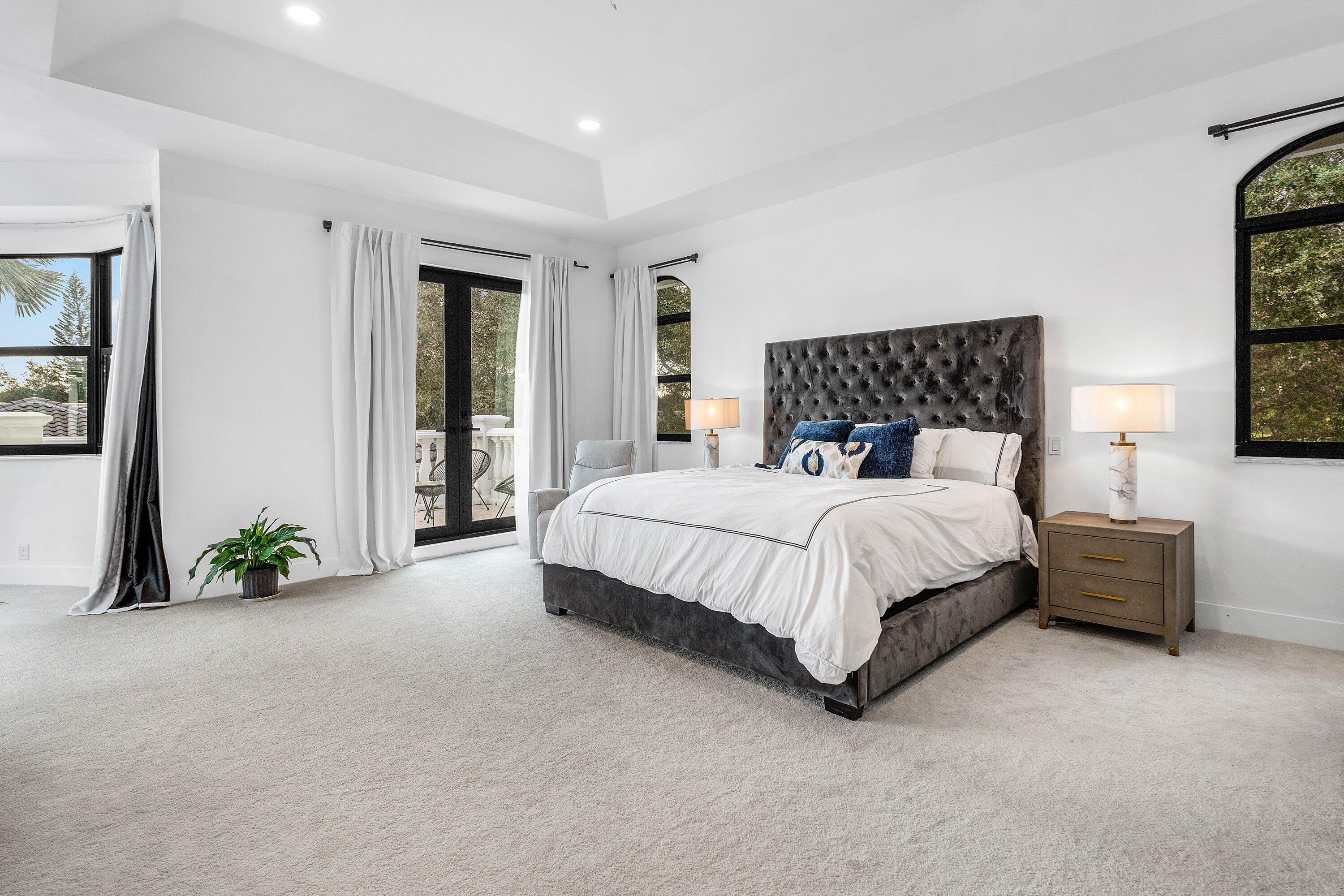 17600 Fieldbrook Circle East Boca Raton, FL 33496 - Photo 36 of 91 a bed sitting in a spacious bedroom next to a window and a chair