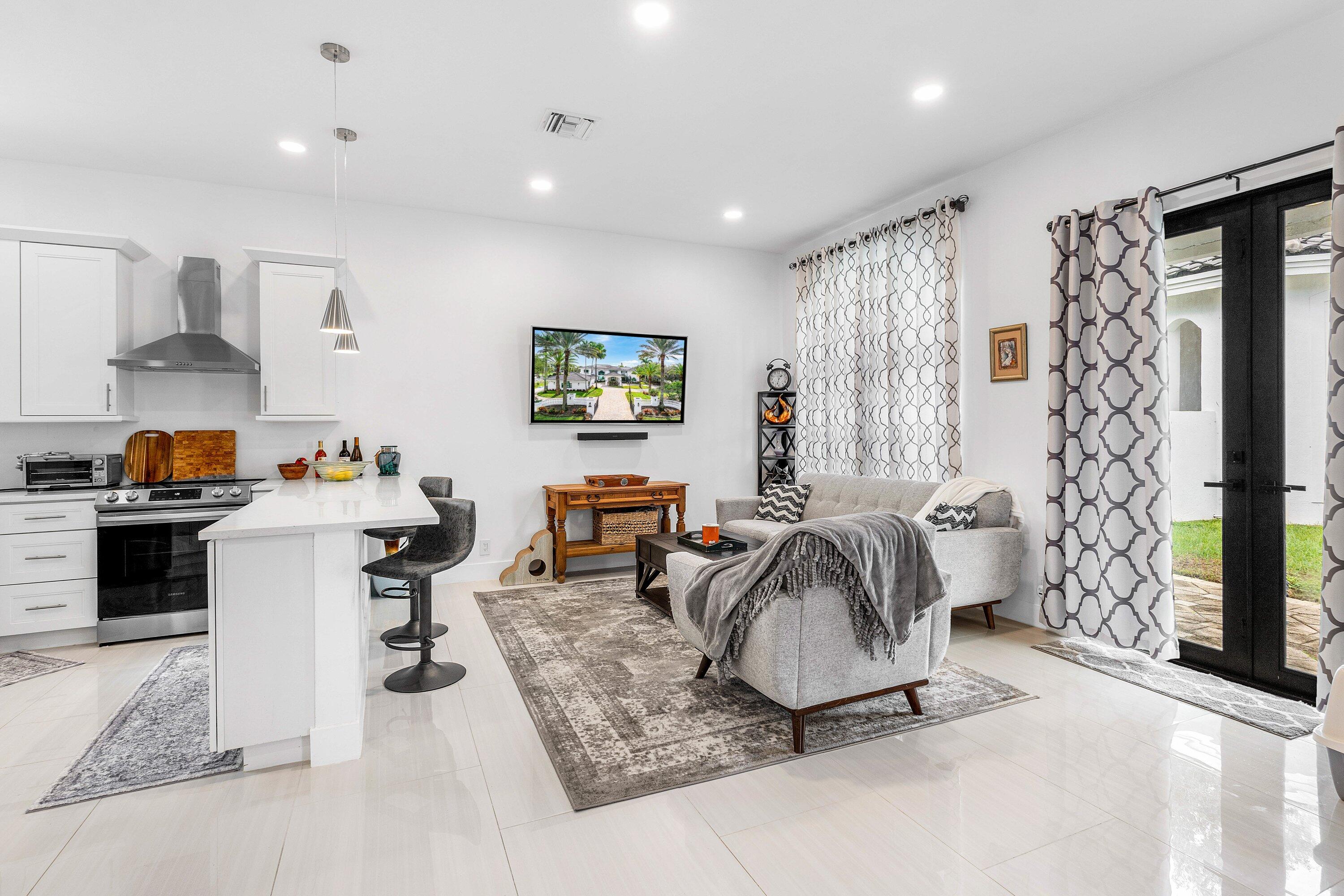 17600 Fieldbrook Circle East Boca Raton, FL 33496 - Photo 50 of 91 a living room with furniture and a flat screen tv