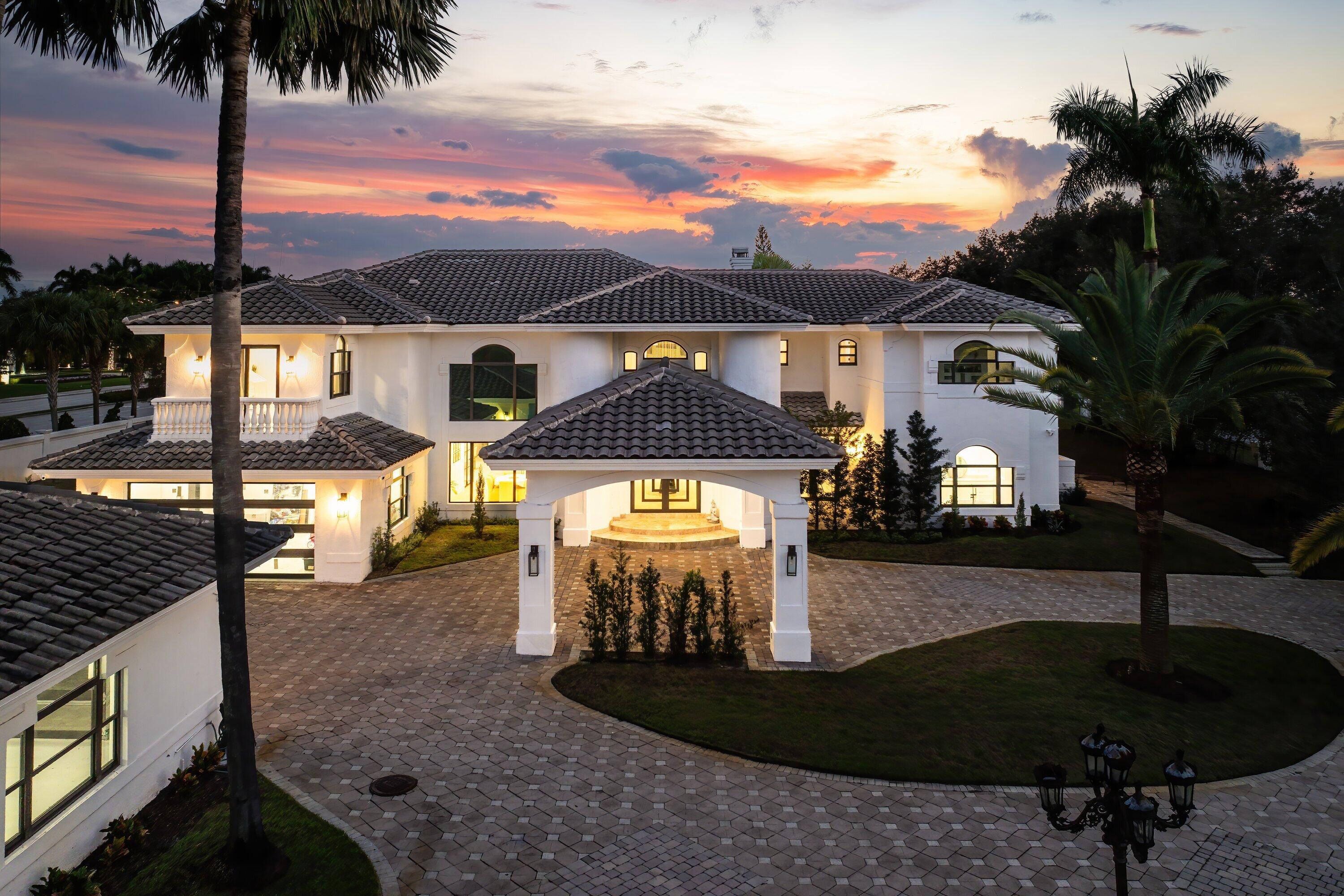 17600 Fieldbrook Circle East Boca Raton, FL 33496 - Photo 80 of 91 a front view of a house with a yard and potted plants