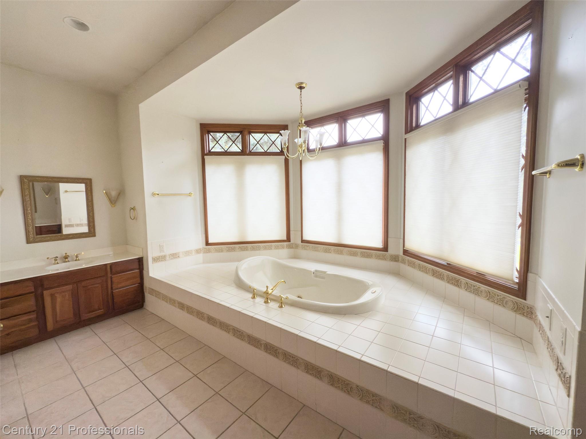 303 East Snell Road Rochester, MI 48306 - Photo 20 of 45 Full bathroom featuring a garden tub, 2 vanities and separate shower and toilet areas.