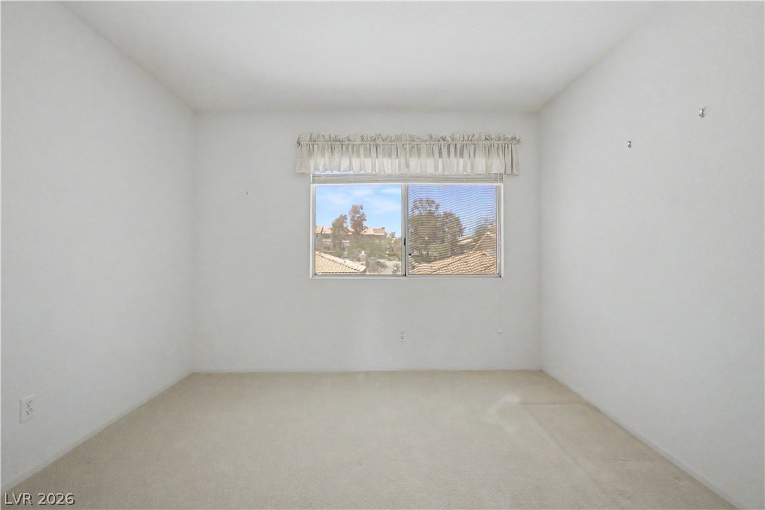 2243 Rugged Mesa Drive Laughlin, NV 89029 - Photo 22 of 32 A quiet bedroom offers serene outdoor views through the window, providing a peaceful retreat.