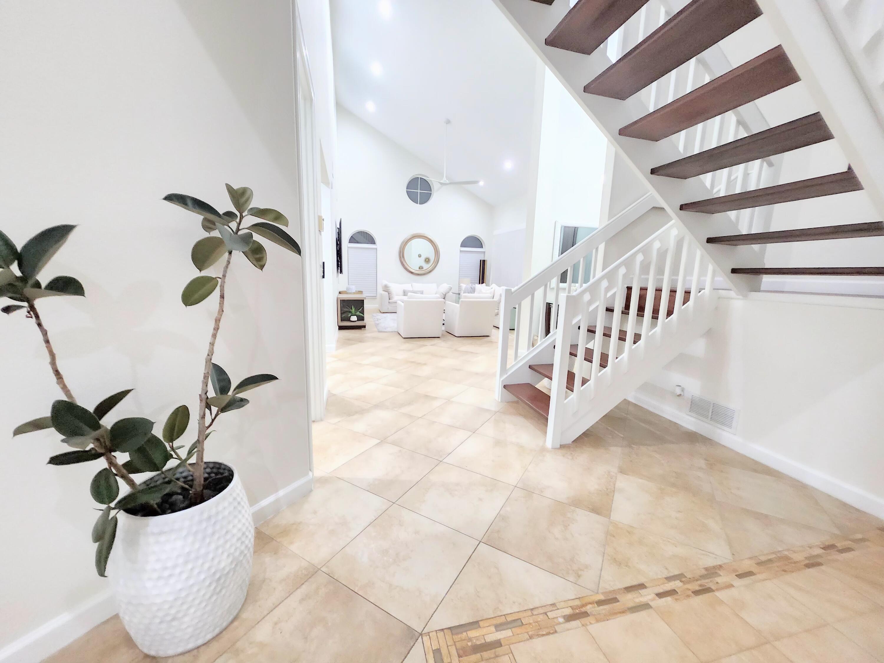 3567 Commodore Circle Delray Beach, FL 33483 - Photo 12 of 76 a view of entryway with a table and a potted plants