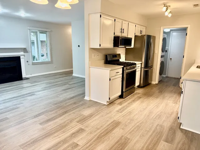 a kitchen with stainless steel appliances a refrigerator stove and microwave