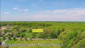 45 Iron Ore Road Manalapan, NJ 07726 - Photo 6 of 25 a view of a outdoor space with a garden and signage