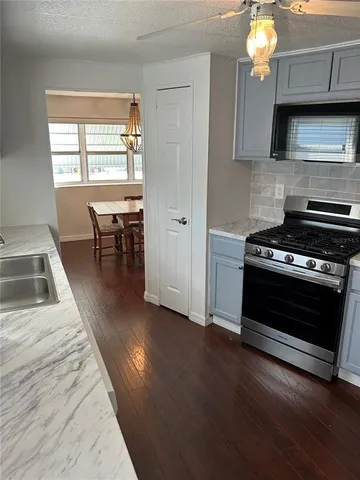 a kitchen with sink cabinets and window