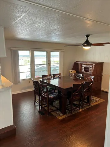 a view of a kitchen with furniture and wooden floor