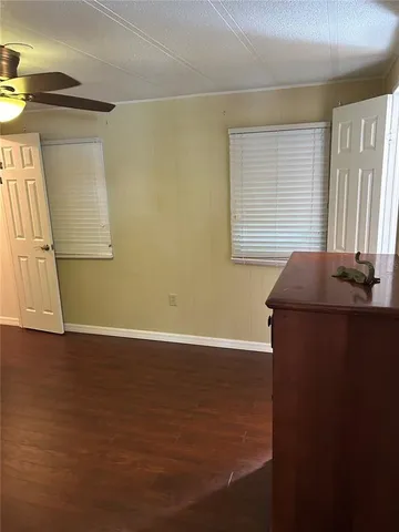 a view of room with window and wooden floor