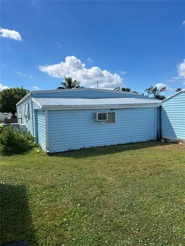 a view of a house with a swimming pool and a yard