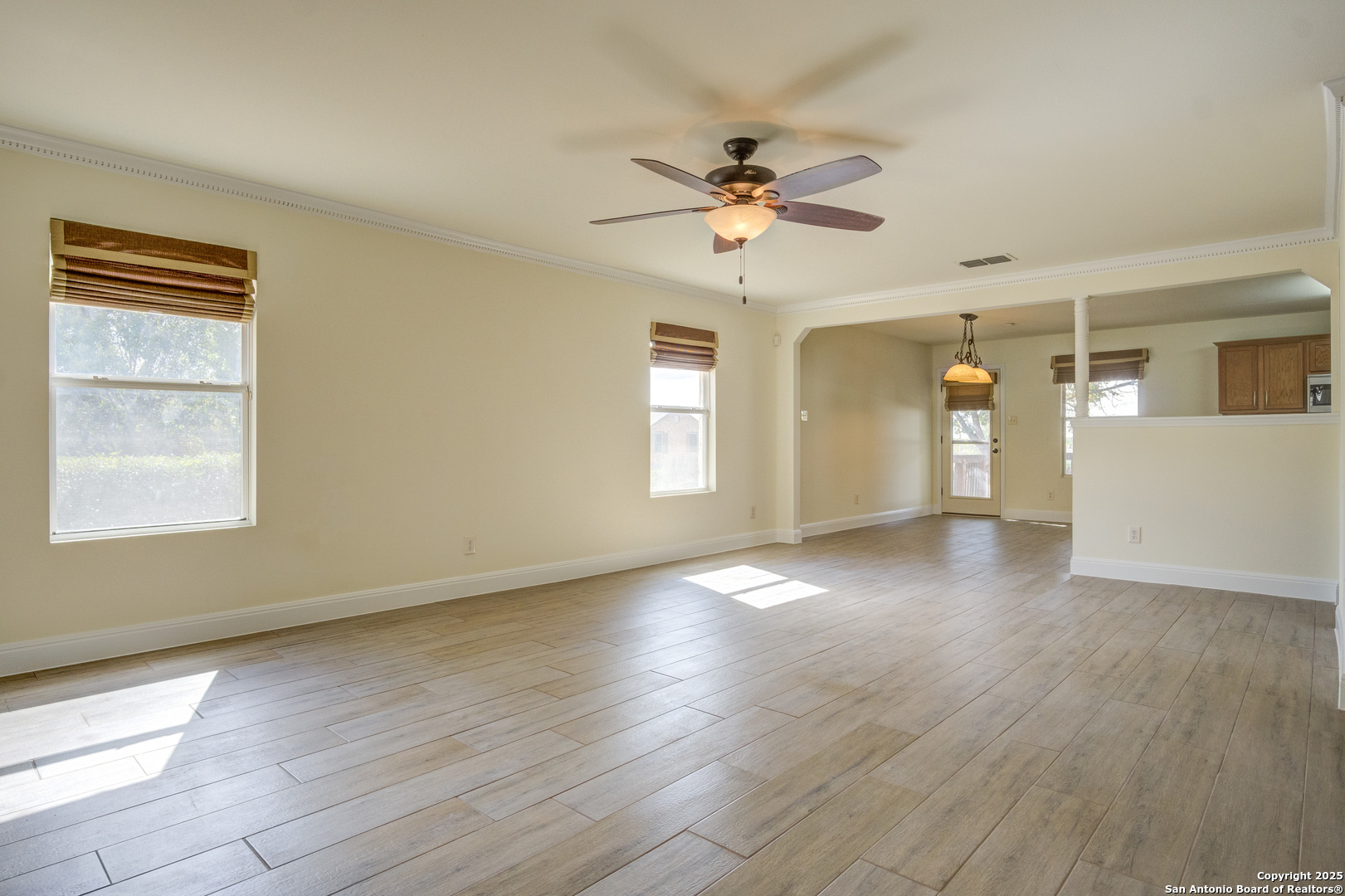 145 Stream Crossing Cibolo, TX 78108 - Photo 17 of 40 a view of an empty room with a window and wooden floor