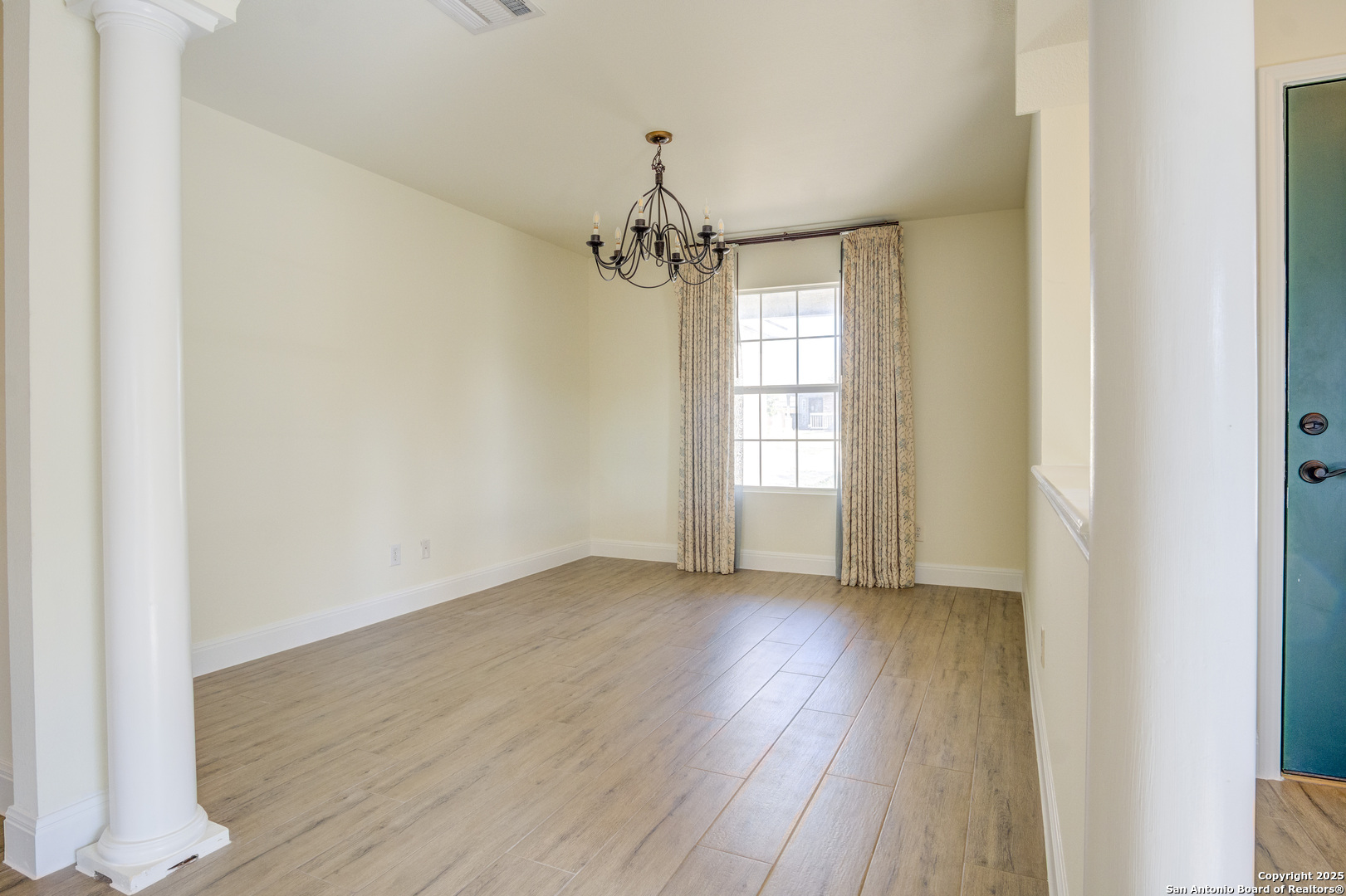 145 Stream Crossing Cibolo, TX 78108 - Photo 18 of 40 a view of an empty room with wooden floor and a window