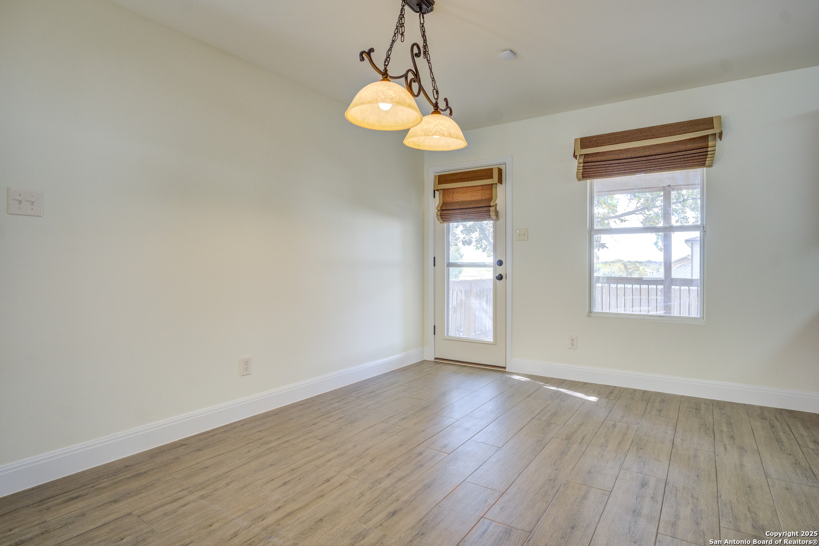 145 Stream Crossing Cibolo, TX 78108 - Photo 20 of 40 a view of an empty room with wooden floor and a window