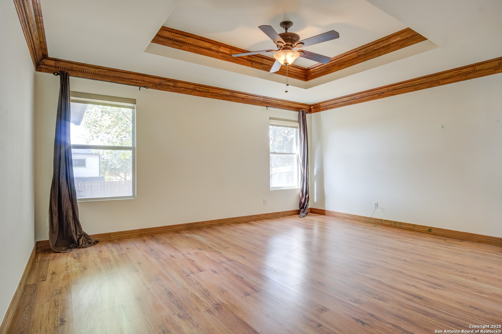 145 Stream Crossing Cibolo, TX 78108 - Photo 25 of 40 an empty room with wooden floor fan and windows