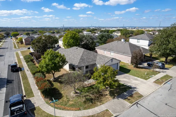 an aerial view of a house with a yard