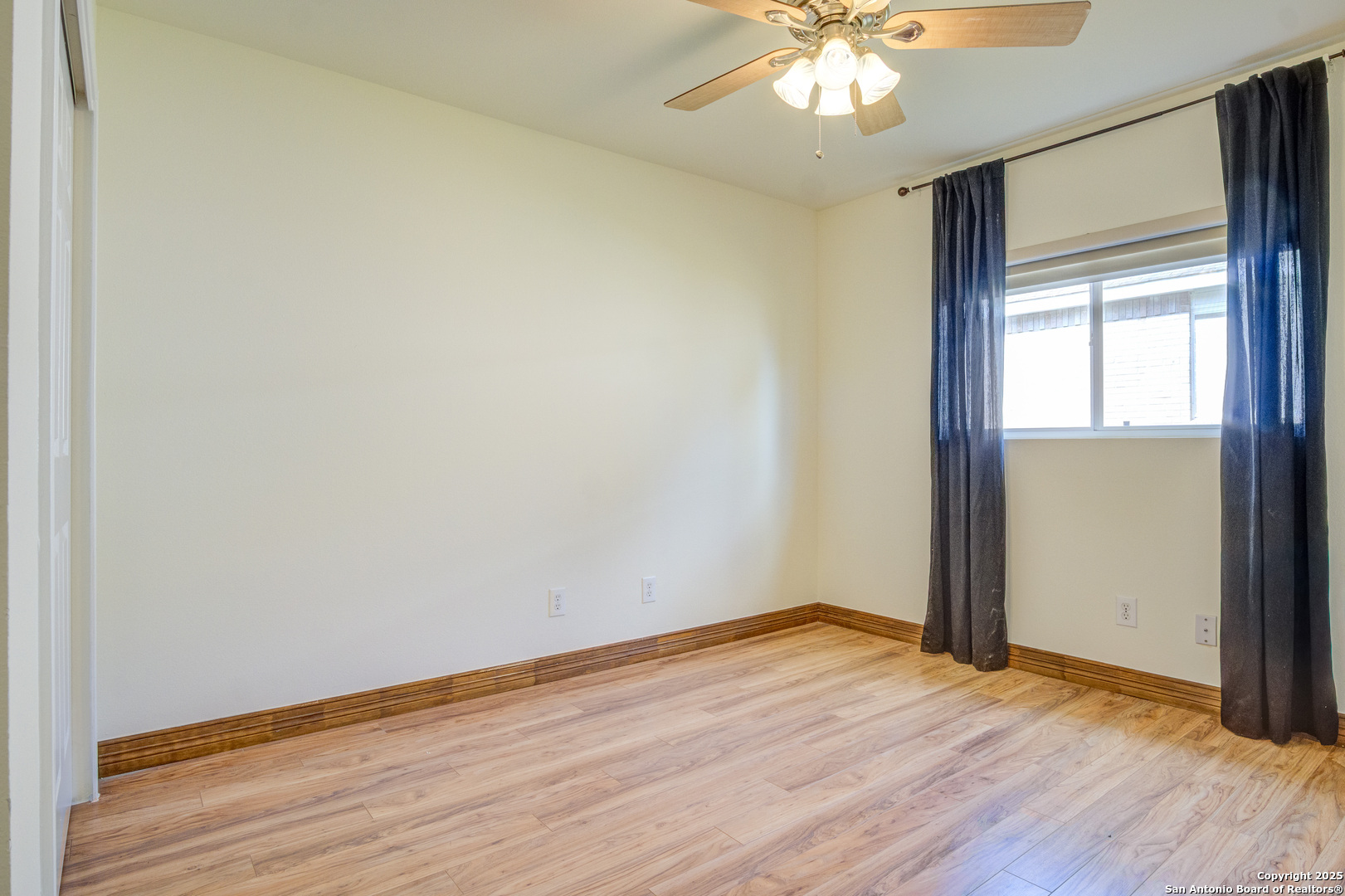 145 Stream Crossing Cibolo, TX 78108 - Photo 31 of 40 an empty room with wooden floor chandelier fan and windows