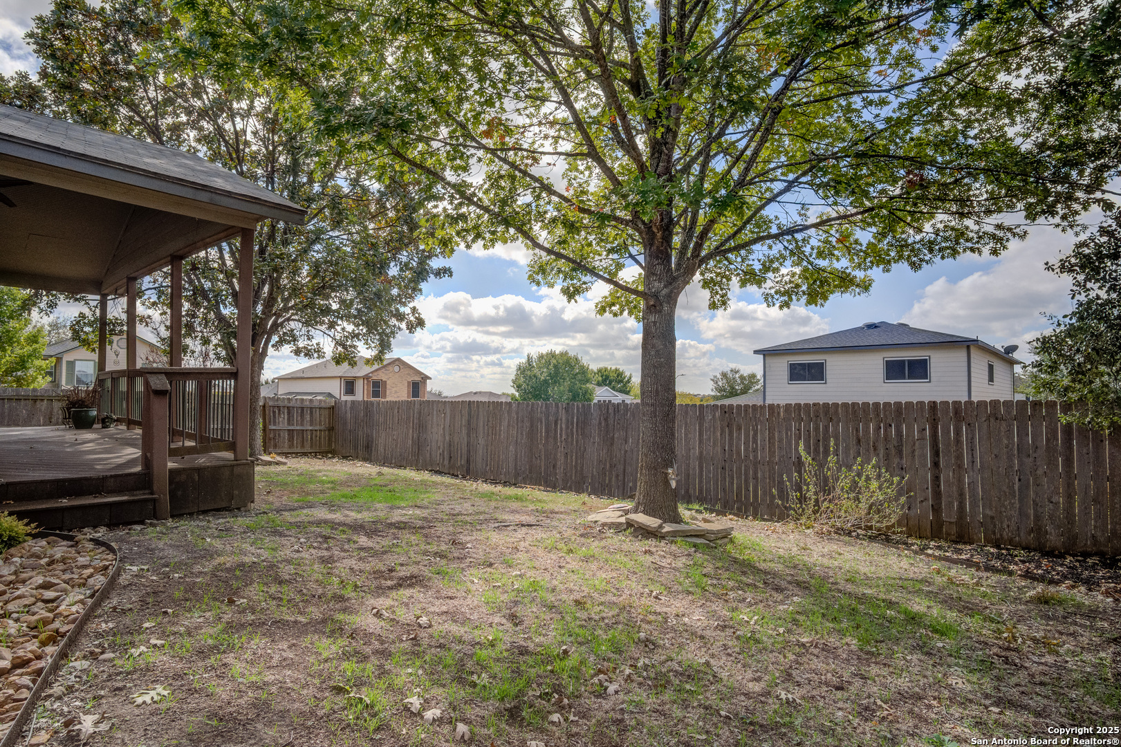 145 Stream Crossing Cibolo, TX 78108 - Photo 37 of 40 a view of backyard with wooden fence and a large tree
